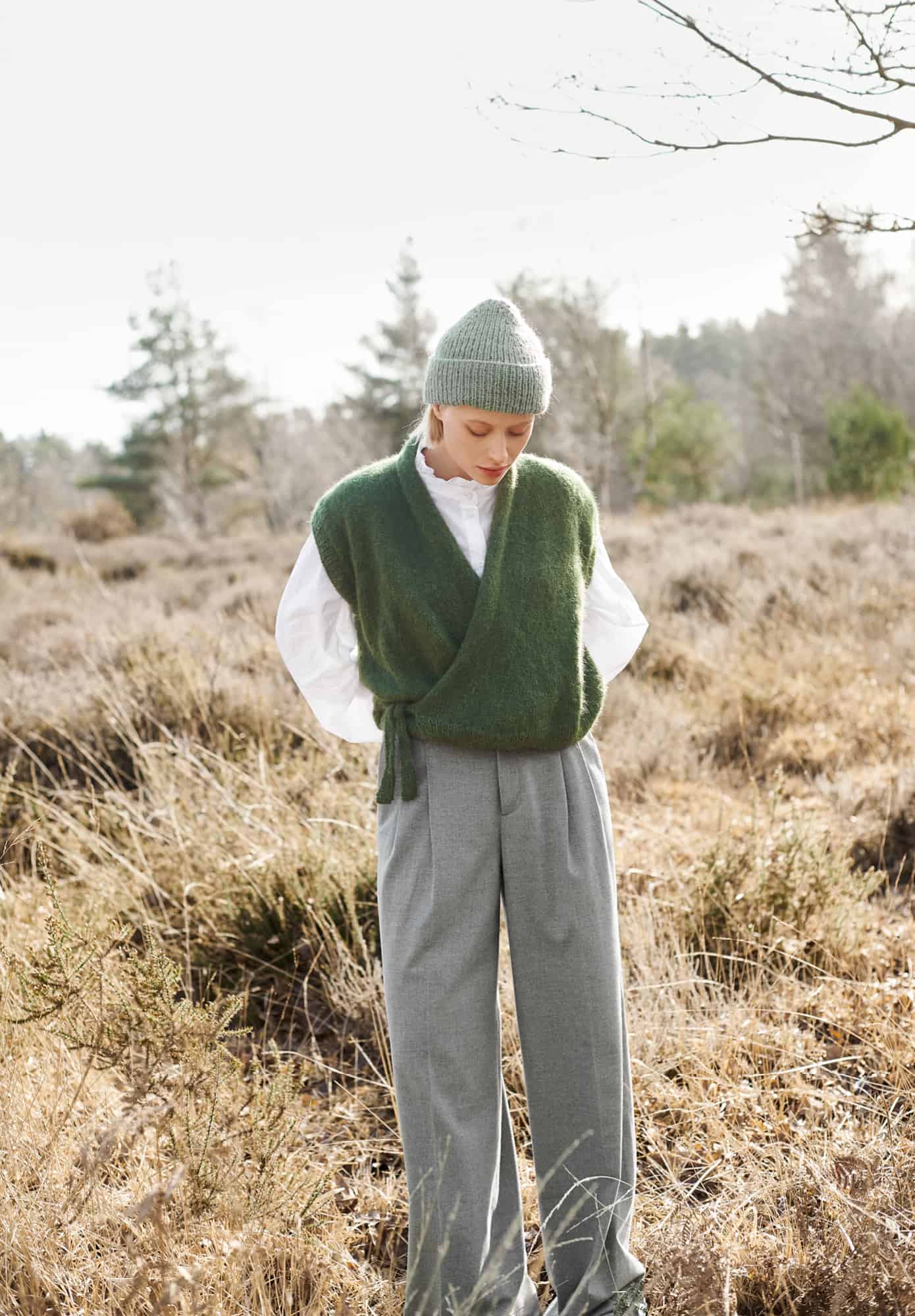 Frau trägt gestrickte Weste in Oliv: Modell 14 aus Lovewool No. 21
