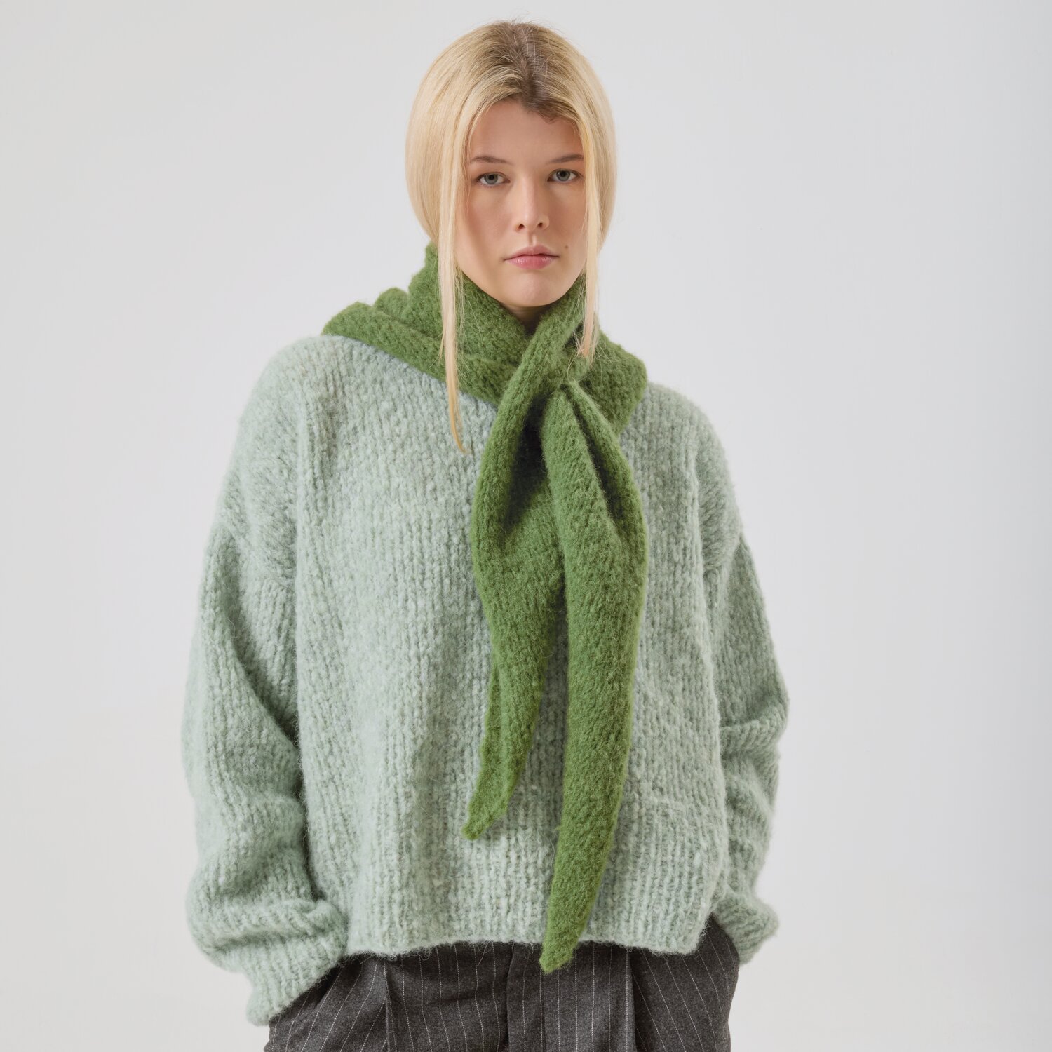 Strickset Dreieckstuch Modell 12 aus Made by Me No. 21 von Rico Design Strickset Dreieckstuch Modell 12 aus Made by Me No. 21: Frau trägt grünes Tuch und mintfarbenen Pullover.