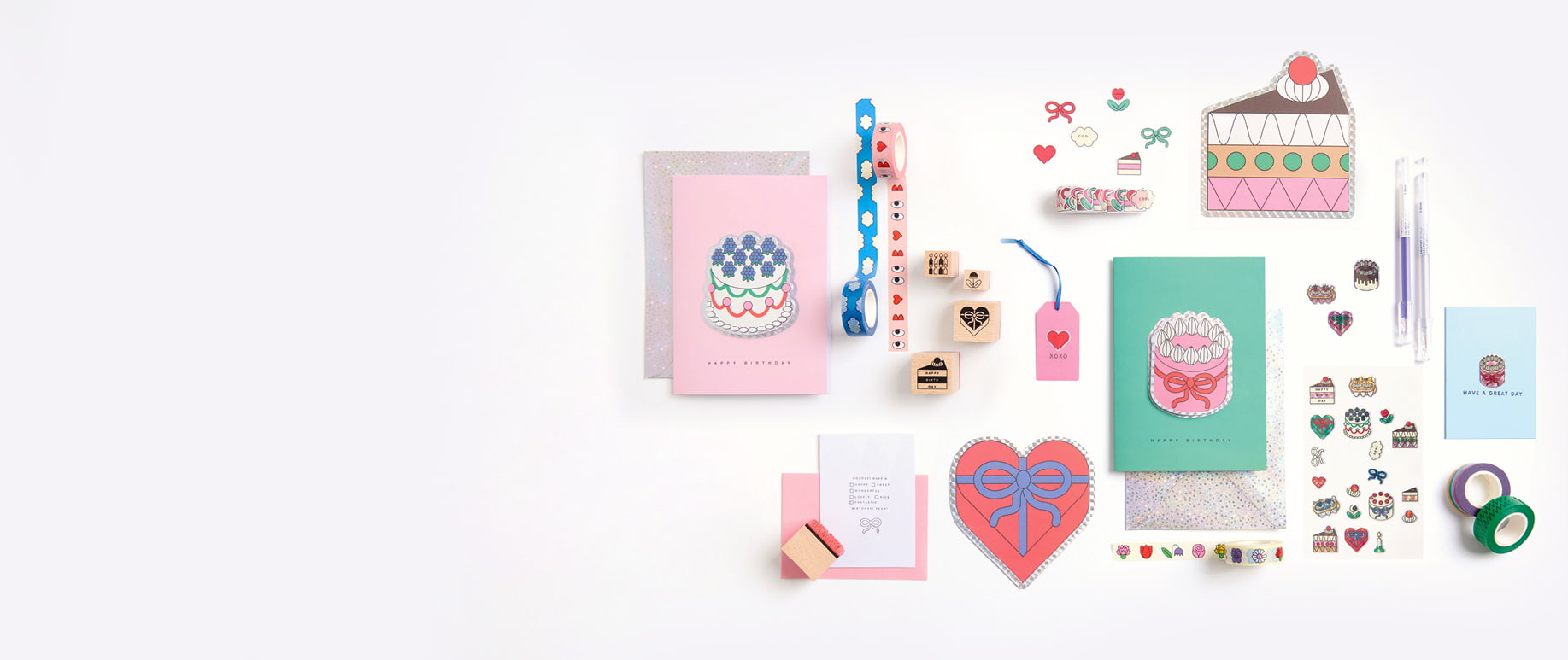 Bunte Karte, Etuis, Sticker, Washi Tapes, Sticker und weitere Papeterie-Artikel aus der Kollektion Eye Candy liegen auf grauem Hintergrund.