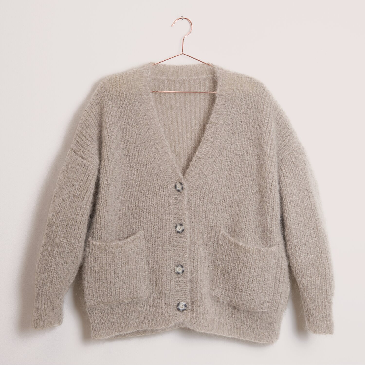 Fashion Mohair Merino aran, 50g, gestrickte Cardigan-Jacke aus Rico Design Garn in Taupe mit V-Ausschnitt, Knopfleiste und zwei aufgesetzten Taschen