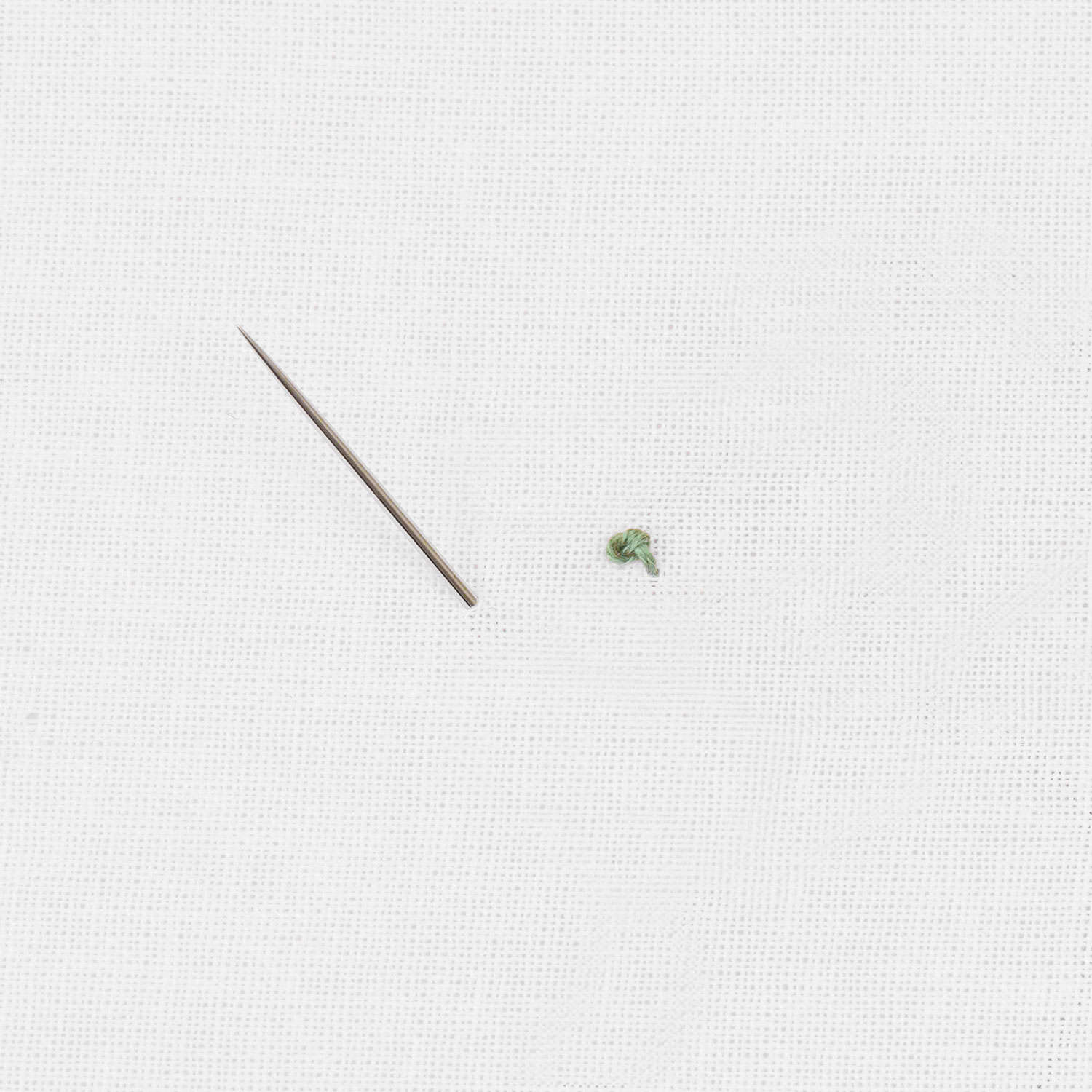 Schritt 1 in der Stickanleitung für einen Knötchenstich