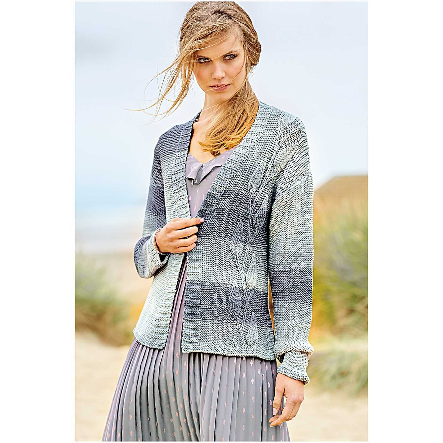 Fashion Colour Spin: Frau trägt gestrickte Jacke in sanften Tönen, ideal für kühle Strandtage.