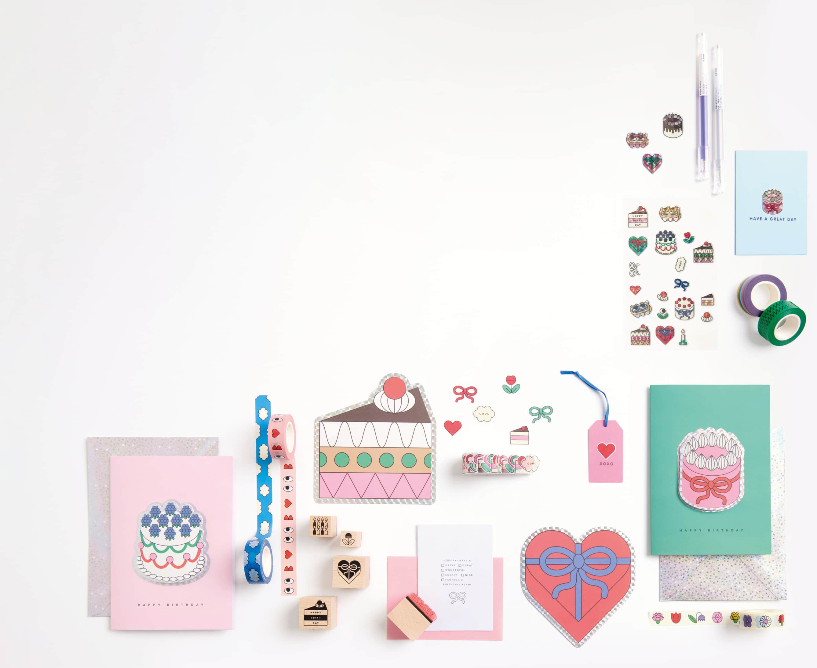 Bunte Karte, Etuis, Sticker, Washi Tapes, Sticker und weitere Papeterie-Artikel aus der Kollektion Eye Candy liegen auf grauem Hintergrund.