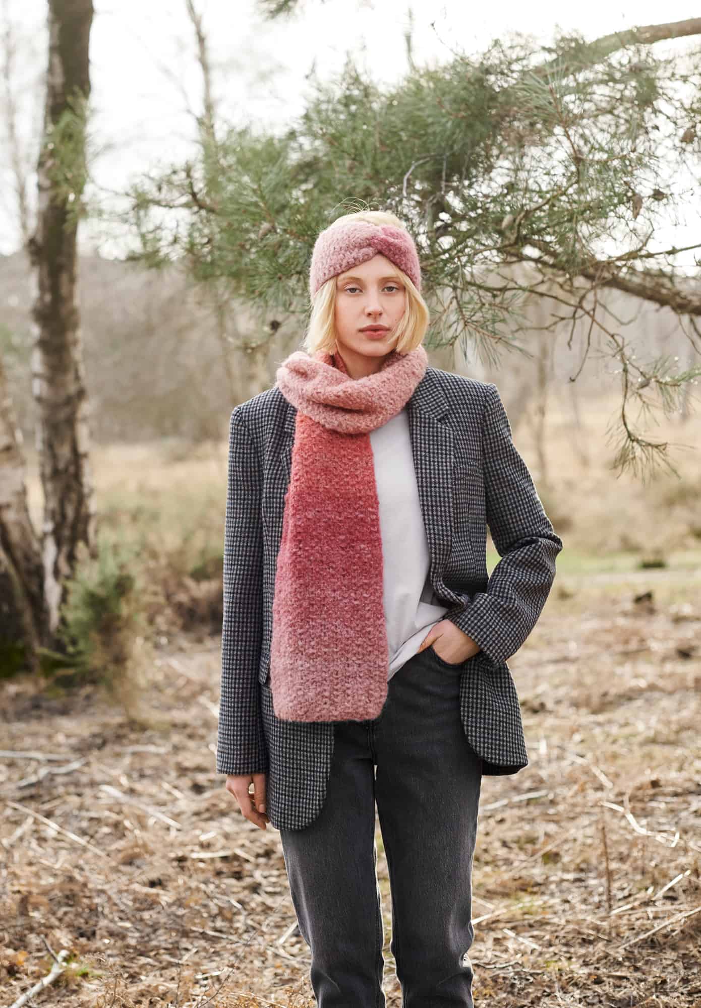 Frau trägt gestricktes Stirnband und gestrickten Schal in Rosa- und Orangetönen: Modell 34 aus Lovewool No. 21